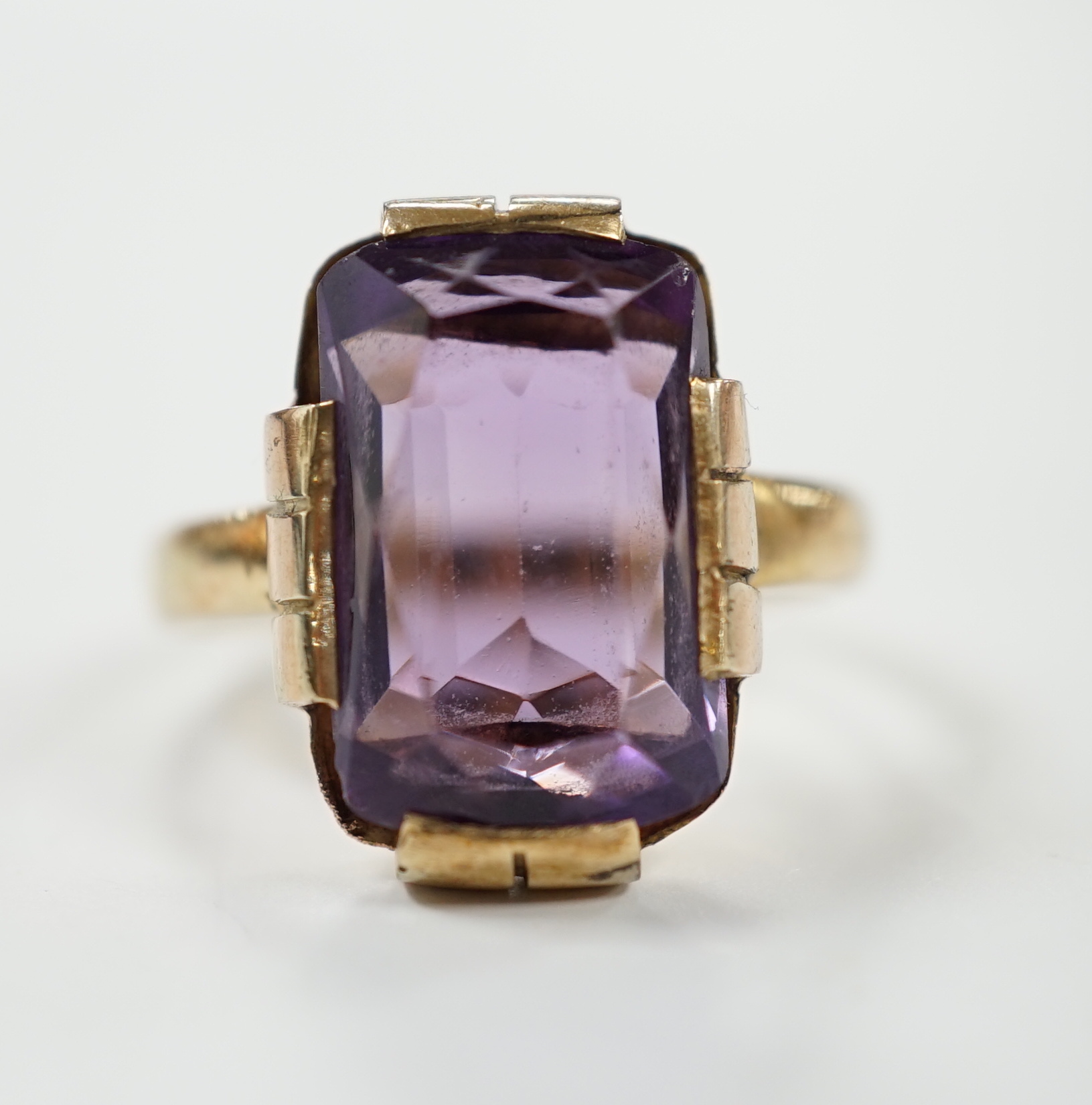 A yellow metal and single stone amethyst set dress ring, size K, gross weight 4.2 grams.